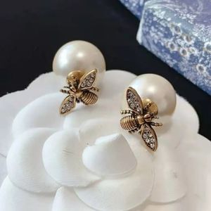 TRIBALES EARRINGS Antique Gold-Finish Metal with White Resin Pearls and a Bee